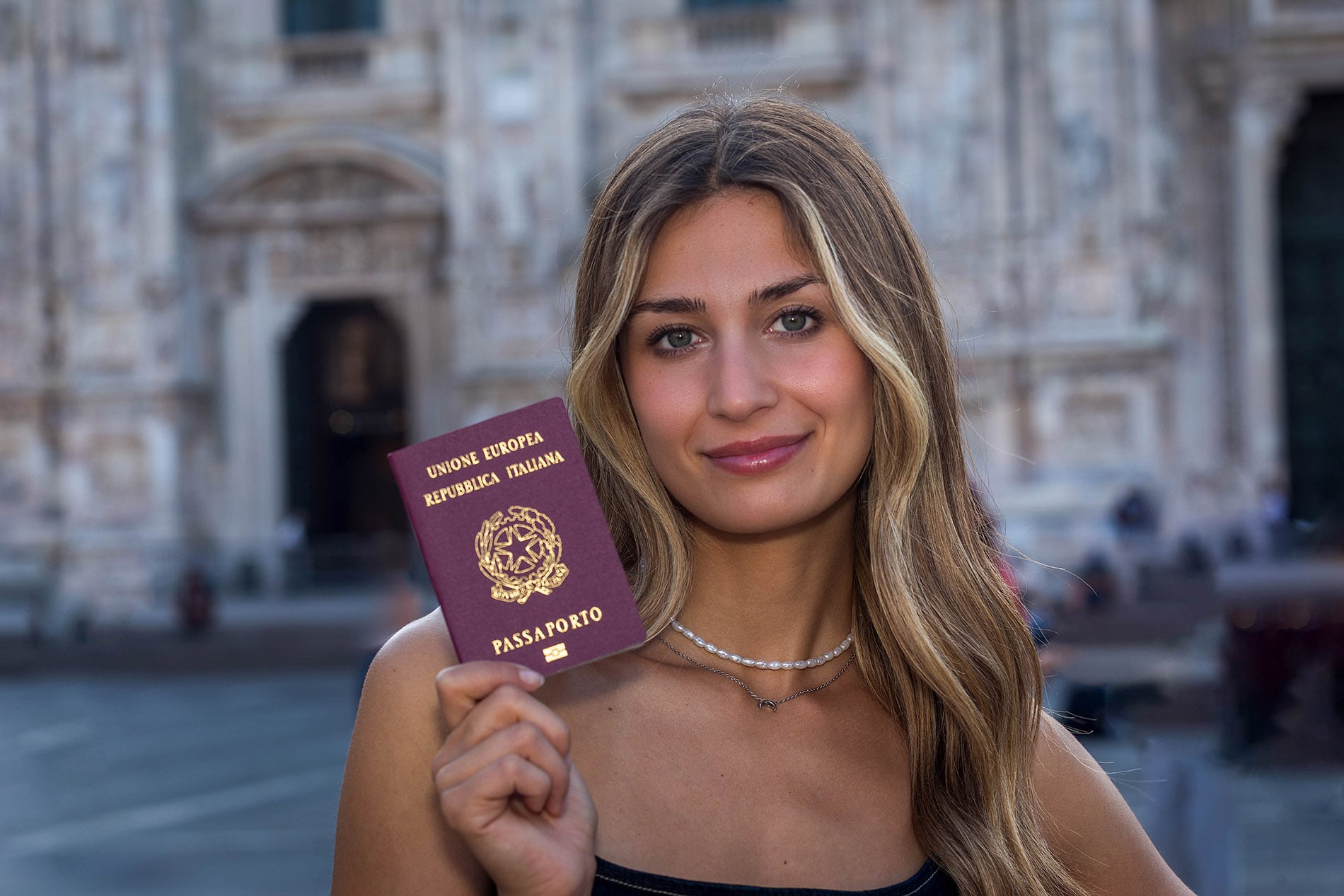 Happy Italian citizenship client with passport